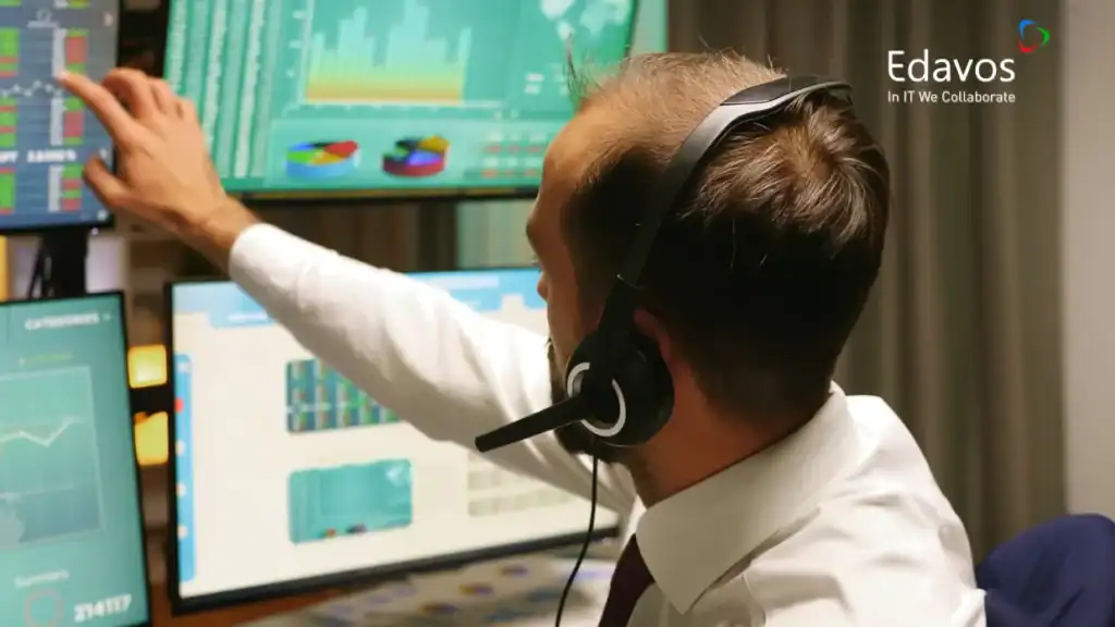 Profesional IT sedang mengelola jaringan kantor bertingkat dengan perangkat komputer dan monitor yang menampilkan data dan grafik untuk memastikan koneksi yang optimal.